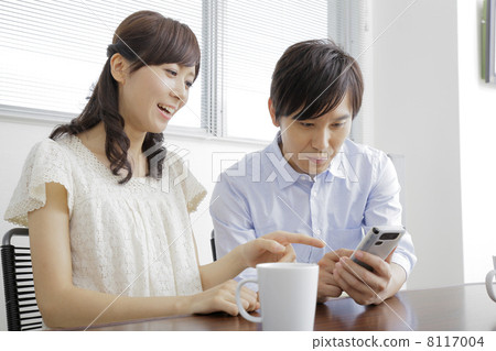 A couple that operates a smartphone A couple that operates a smartphone 8117004
