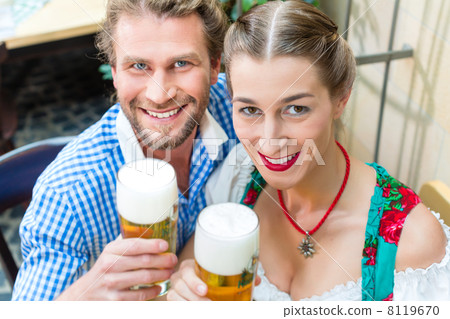 Young couple in Bavaria in restaurant or pub 8119670
