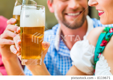 Young people in Bavarian Tracht in restaurant or pub 8119671