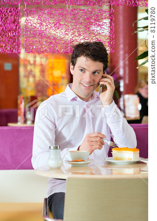 Young man in ice cream parlor 8119780