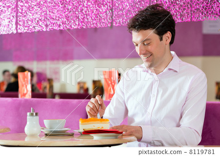 Young man in ice cream parlor 8119781