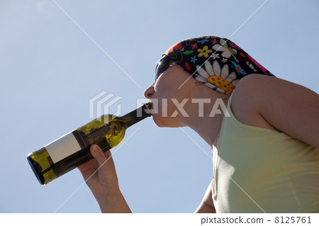profile of woman drinking from wine bottle 8125761
