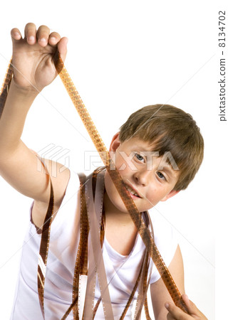 Young boy with celluloid movie Young boy with celluloid movie 8134702