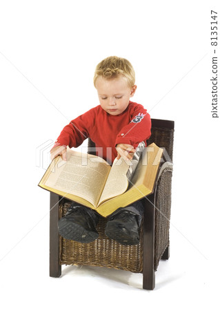 Little boy with heavy book 8135147