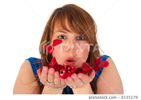 Beautiful girl blowing rose leaves 8135179
