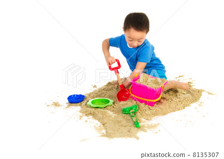 Chinese boy playing at the beach Chinese boy playing at the beach 8135307