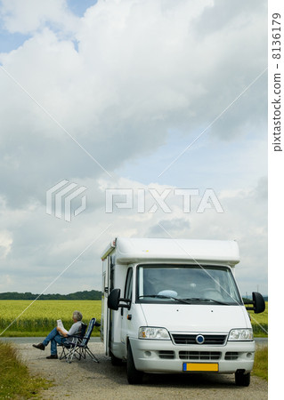 Man relaxing by his campingcar Man relaxing by his campingcar 8136179