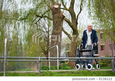 Elderly woman with walker 8136222