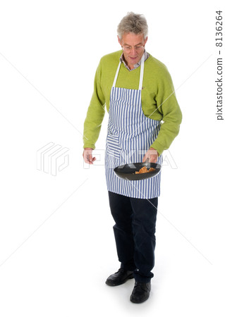 Elderly man is baking pancakes 8136264