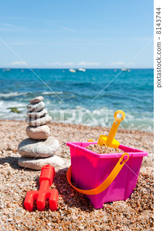 Pile of stacked stones with toys 8143744