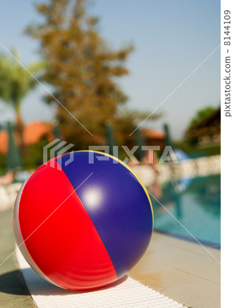 Beach ball near swimming pool Beach ball near swimming pool 8144109