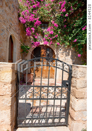 House exterior with pink flowers in Greece House exterior with pink flowers in Greece 8144528