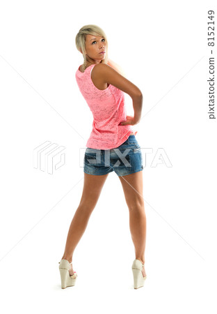 Sexy girl in denim shorts looks back at the studio. View from th Sexy girl in denim shorts looks back at the studio. View from th 8152149