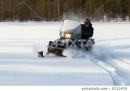 man riding a snowmobile 8152458
