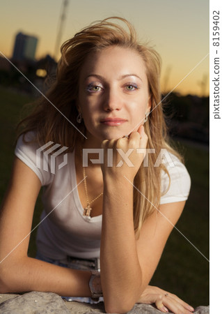 half-length portrait of 20s blond caucasian young pretty woman in sunset lightning looking at camera half-length portrait of 20s blond caucasian young pretty woman in sunset lightning looking at camera 8159402