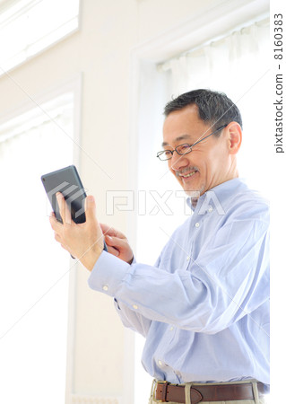 Senior men using tablet PC Senior men using tablet PC 8160383
