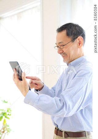Senior men using tablet PC Senior men using tablet PC 8160384
