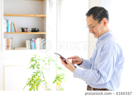 Senior men using tablet PC Senior men using tablet PC 8160387