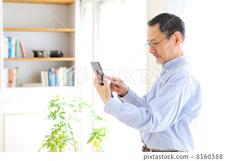 Senior men using tablet PC Senior men using tablet PC 8160388
