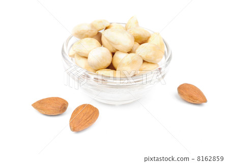 Dried  peeled almonds on glass bowl isolated on a white background 8162859