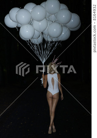 Woman holding Latex Air Balloons in the Darkness Woman holding Latex Air Balloons in the Darkness 8164932
