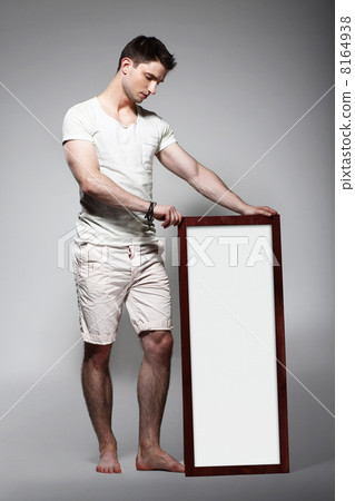 Shoeless Man Displaying White Board with Blank Space 8164938