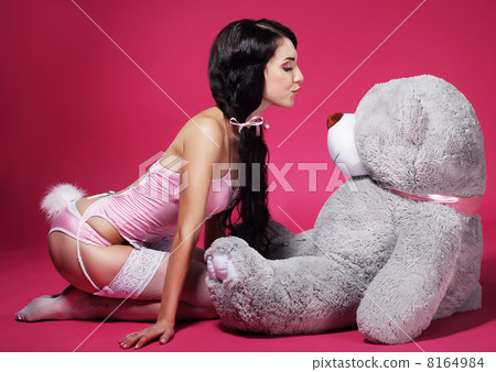 Seductive Playful Woman in Pink Lingerie with Teddy Bear 8164984