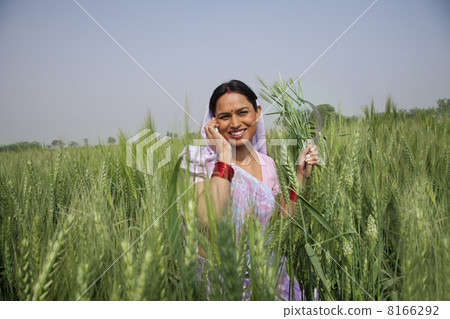 Portrait of an Indian female farm worker talking on phone 8166292