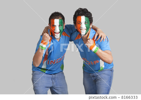 Excited male cricket supporters with face painted in tricolor cheering over colored background 8166333