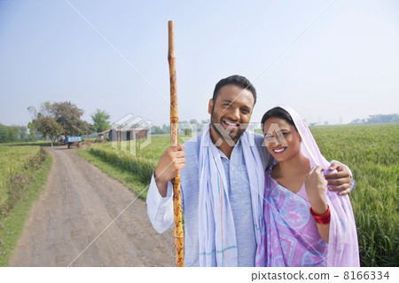 Portrait of an Indian couple smiling with field in background 8166334