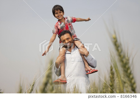 Portrait of a man carrying little boy on shoulders 8166346