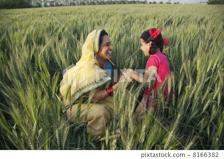 Happy mother and daughter playing in the field 8166382
