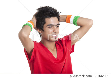 Disappointed young boy looking away with hands behind head over white background 8166416