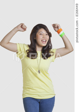 Portrait of happy young woman in casuals cheering over white background Portrait of happy young woman in casuals cheering over white background 8166449