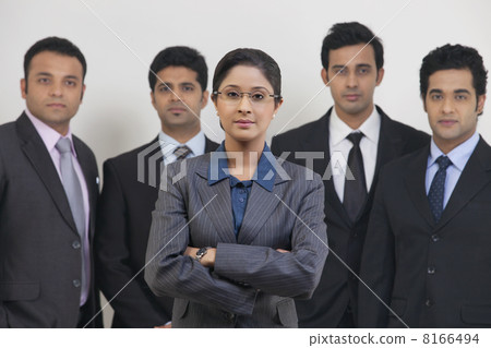 Group portrait of confident business people standing against gray background 8166494