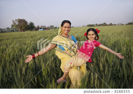 Portrait of carefree mother and daughter with arms out 8166555