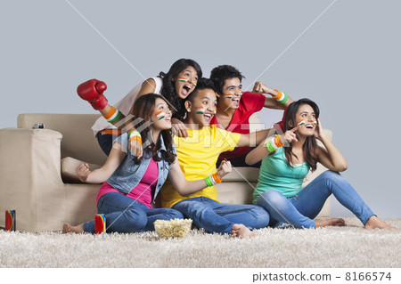 Excited young friends watching a boxing match together at home 8166574