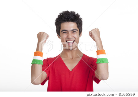Portrait of happy teenage boy in red t-shirt cheering with clenched fists over white background 8166599