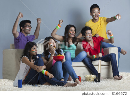 Young friends watching hockey match together at home 8166672