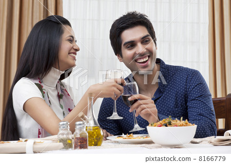 Cheerful young couple enjoying the meal at restaurant Cheerful young couple enjoying the meal at restaurant 8166779