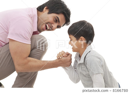 Cheerful father and son arm wrestling over white background Cheerful father and son arm wrestling over white background 8166780
