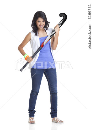 Full length portrait of young female in casual wear holding hockey stick over white background Full length portrait of young female in casual wear holding hockey stick over white background 8166781