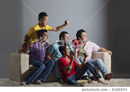 Excited male friends cheering out while watching boxing match together at home 8166854