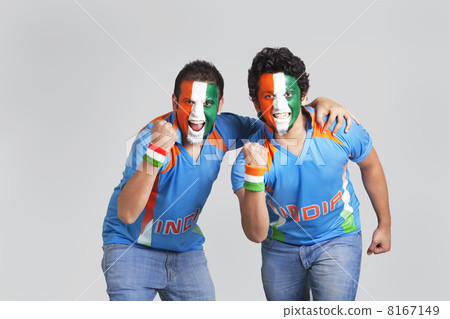 Exhilarated male cricket supporters with a painted face in tricolor cheering over colored background 8167149