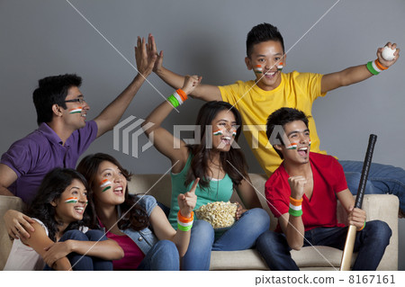 Excited young friends enjoying cricket match together at home Excited young friends enjoying cricket match together at home 8167161