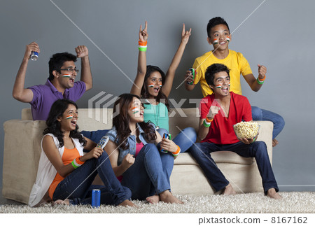 Enthusiastic young friends having great fun together at home Enthusiastic young friends having great fun together at home 8167162