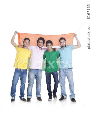 Full length portrait of young male friends in casuals holding Indian flag over white background 8167163