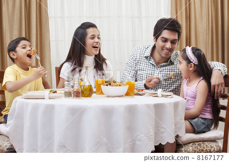 Happy parents and children eating pizza together at restaurant Happy parents and children eating pizza together at restaurant 8167177
