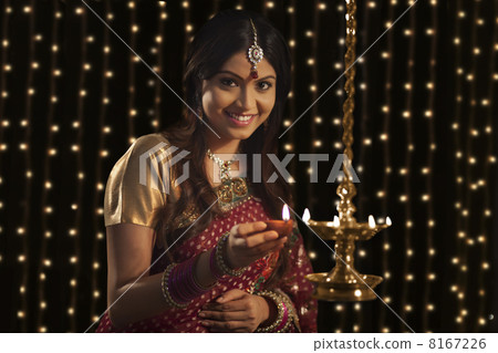 Portrait of woman with a diya 8167226