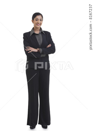 Full length portrait of confident businesswoman with arms crossed standing against white background 8167237